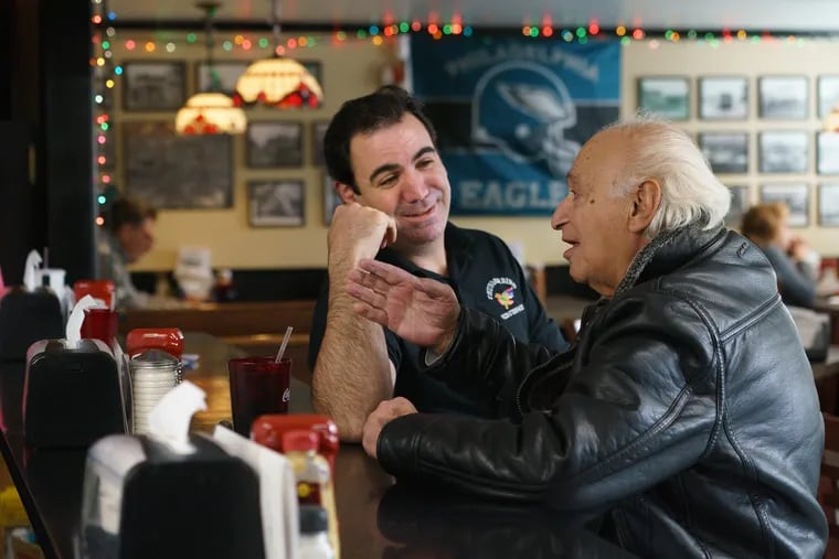Owner Tom Greco (left) talks with longtime customer George Dulgerian at Thunderbird steak and pizza shop, where cries of "Go, Birds!" have been heard for weeks. The Broomall restaurant was started in 1956 by Greco's grandfather Salvatore.