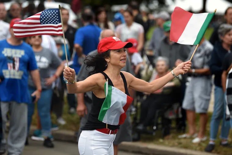 Diane Pelosi, of Williamstown, N.J., dances to the music of a string band along South Broad Street in South Philly during the annual Columbus Day Parade and Italian American festival Sunday.
