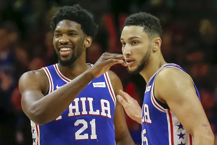 Sixers center Joel Embiid with teammate Sixers guard Ben Simmons after Embiid drew a technique foul on the Utah Jazz during the fourth-quarter on Monday, November 20, 2017 in Philadelphia.