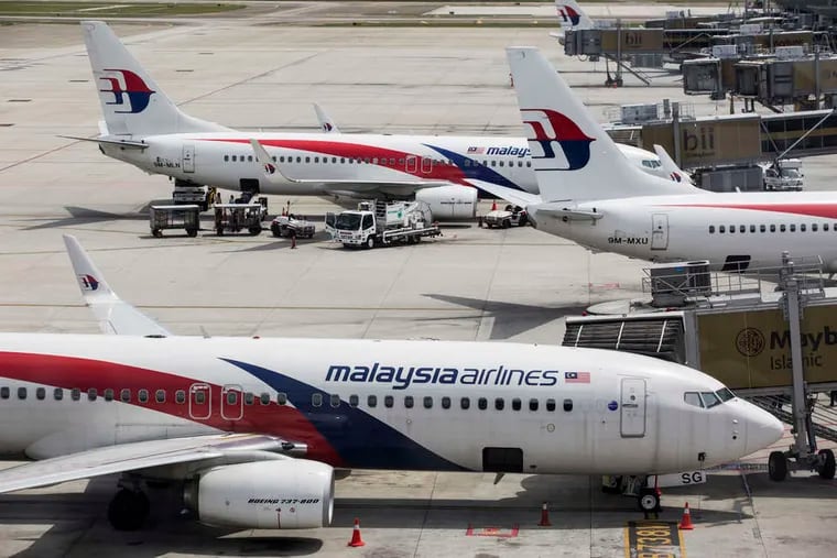 A Malaysia Airlines flight disappeared in March; another was shot down over Ukraine in July. Financial losses are mounting. Here, planes in Kuala Lumpur.