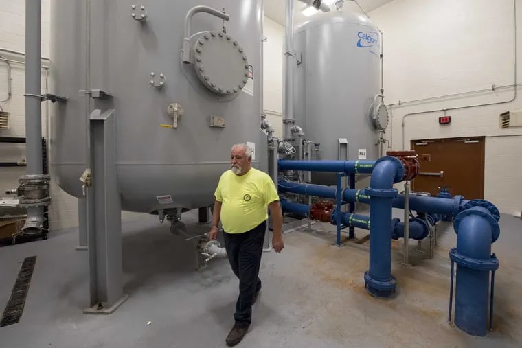 In 2017, carbon filters to clean water contaminated by PFAS were installed in Horsham Township, inspected here by Ted DeLeone, director of field operations for the Horsham Water & Sewer Dept. The tanks can also be used for ion exchange systems, an alternative treatment to carbon filters that Horsham, Warrington, and Warminster Townships want to permanently employ.