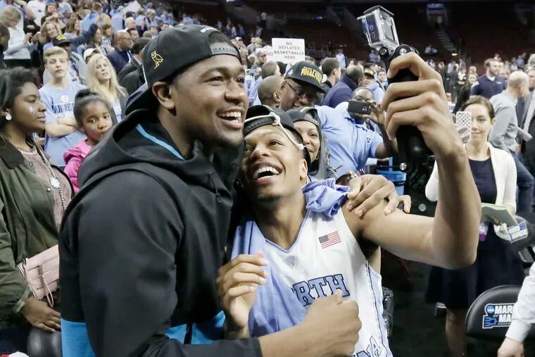 Kris Jenkins (left) with North Carolina player Nate Britt Jr., his brother from his guardian family.