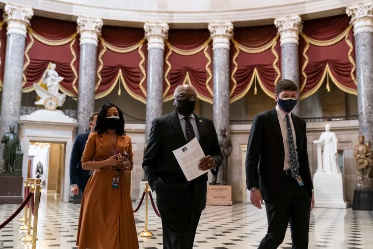 House Majority Whip James Clyburn of S.C., center, walks through Statuary Hall before the vote on the Democrats' $1.9 trillion COVID-19 relief bill on Capitol Hill on Wednesday.