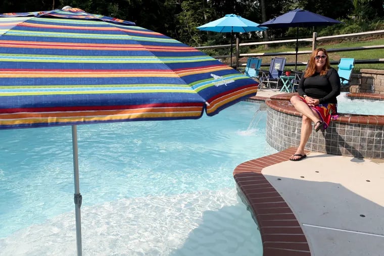 Mel Stewart by her pool at her home in Newtown Square. The Stewarts recently starting using the pool sharing service, Swimply, which allows homeowners to rent out their personal pools.