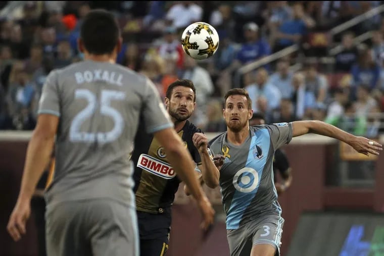 Minnesota United midfielder Jerome Thiesson and Philadelphia Union forward Chris Pontius chase down a loose ball during the first half.