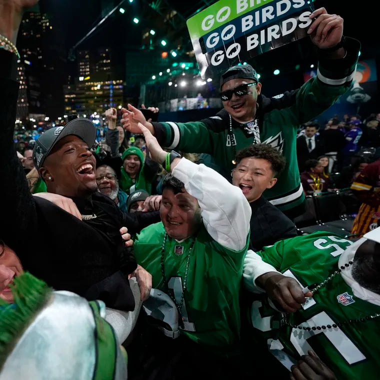 Quinyon Mitchell celebrates with fans after being chosen by the Philadelphia Eagles with the 22nd overall pick during the first round of the NFL draft Thursday.