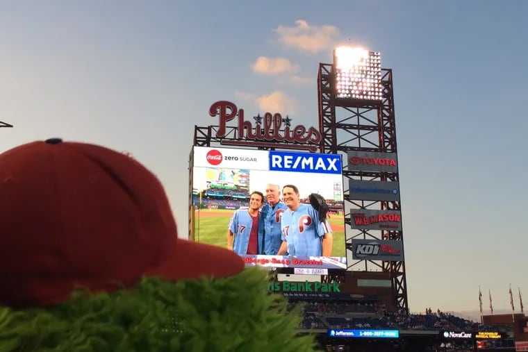 With the Phillie Phanatic looking on, Phillies legend Mike Schmidt (center) with actor Troy Gentile (left), who plays Barry Goldberg on ABC's &quot;The Goldbergs,&quot; and the real Barry Goldberg, whose brother Adam is the show's creator, pose together at Citizens Bank Park on Sept. 15, 2017. This event, in which Schmidt surprised Goldberg and fans by showing up to catch as Barry Goldberg threw out the first pitch, inspired the May 2 episode of “The Goldbergs”