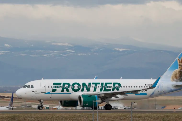 A Frontier Airlines jetliner taxis to a runway to take off from Denver International Airport in 2020.