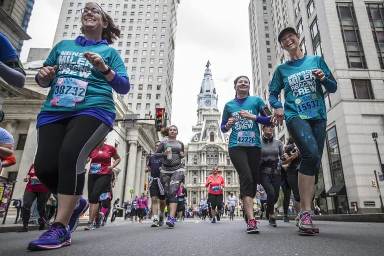 From left to right, Zarabeth Davis, Erin Siegle and Amy Weigand pass City Hall on their way to the Navy Yard during the 2017 Broad Street Run.