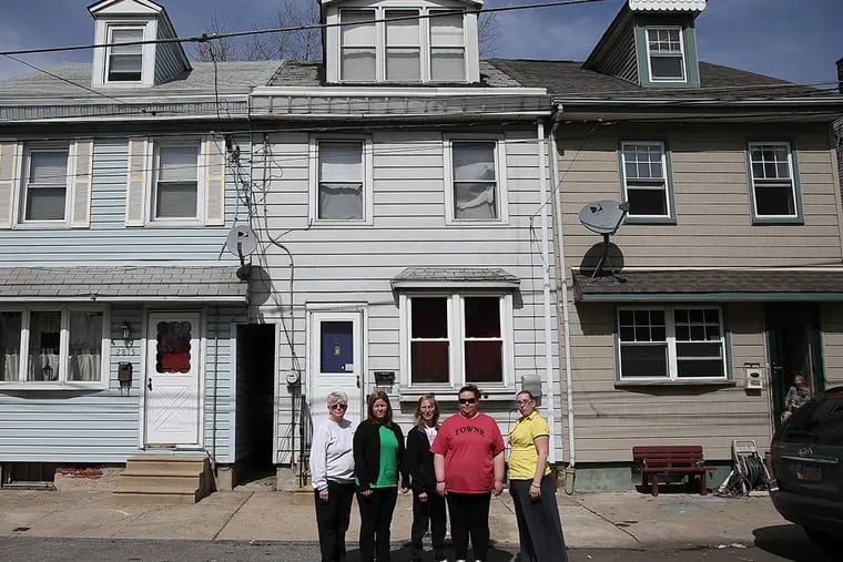 Neighbors (from left) Donna McGrath, Kelly McGrath, Suzanne Galson, Danielle Carbaugh and Stefanie Carbonaro in front of Reynolds Street home that has haunted them. (DAVID MAIALETTI / STAFF PHOTOGRAPHER)