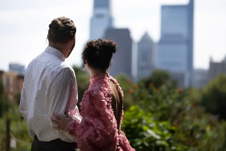 Dan Barone and Nicole Wyglendowski take in the Philly skyline at Corinthian Gardens in Fairmount. The couple will get married at the gardens on Friday, Oct. 13.
