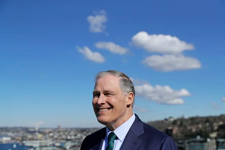 In this March 1, 2019 photo, Washington Gov. Jay Inslee stands on an outdoor patio as he takes part in media interviews in Seattle the day he announced that he will seek the 2020 Democratic presidential nomination. Inslee kicked off his campaign with a call for making the fight against climate change the "first, foremost and paramount duty" of the United States. (AP Photo/Ted S. Warren)