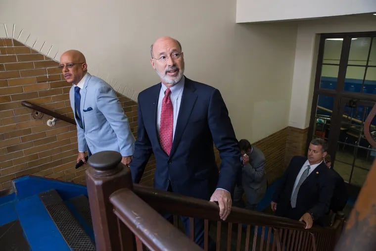 State Sen. Vincent Hughes, left, and Gov. Tom Wolf, center, arrive at Roosevelt School in Philadelphia, prior to a press conference to announce upcoming school building improvement projects at the Roosevelt School and other Philadelphia Schools, in Philadelphia, Friday, June 29, 2018.