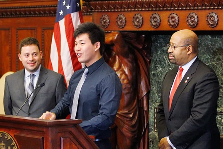 Wei Chen (center), 20, is the recipient of a $50,000 peace-activist grant. He speaks at a City Hall press conference attended by Eric Dawson (left), president and founder of Peace First, and Mayor Michael Nutter on December 19,  2013. ( MICHAEL S. WIRTZ / Staff Photographer )