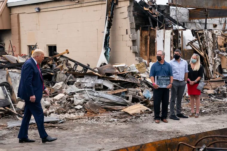 President Donald Trump tours an area on Tuesday, Sept. 1, 2020, damaged during demonstrations after a police officer shot Jacob Blake in Kenosha, Wis.