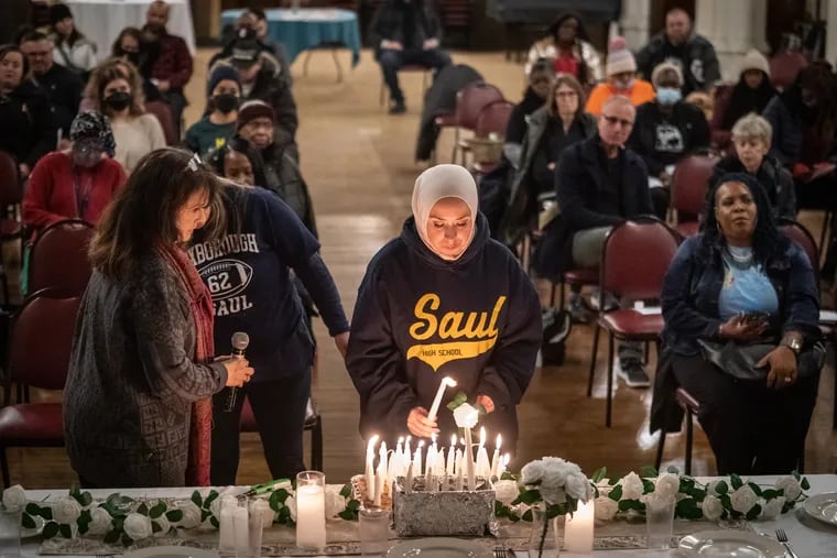 Meredith Elizalde says her son's name, Nicolas Elizalde, and lights a candle for him at a vigil to honor those lost to gun violence. Nicolas, 14, was shot and killed leaving a football scrimmage at Roxborough High School in September.