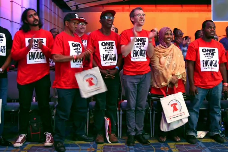 Union members of UNITE HERE stand during the opening of the first-ever "Workers' Presidential Summit" at the Convention Center in Philadelphia, Tuesday, Sept. 17, 2019. The Philadelphia Council of the AFL-CIO hosted the event. (Tom Gralish/The Philadelphia Inquirer via AP)