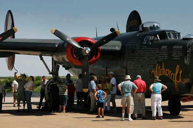 A crowd, right, looks over a B-24 nicknamed &quot;Witchcraft&quot; at the exhibition at Chester County G.O. Carlson Airport. Above, the interior was open for view. The three aircraft will be on display through Wednesday at the airport near Coatesville. The other craft are a B-17 Flying Fortress and a P-51 Mustang. They are owned by the Collings Foundation.