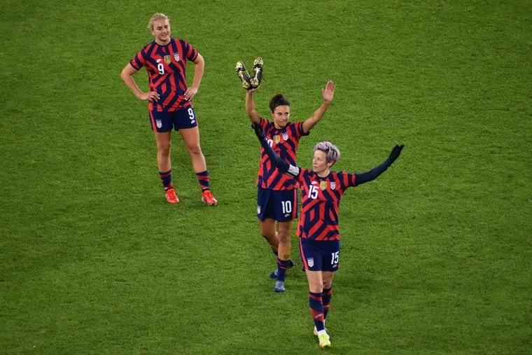 Carli Lloyd (10) waves to the crowd as Megan Rapinoe (15) leads the cheers and Lindsey Horan (9) looks on as Lloyd prepares to leave the field during her last U.S. national team game, Tuesday night against South Korea at Allianz Field in St. Paul, Minn.