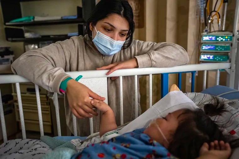 A mother keeps a watchful eye on her 16-month-old daughter who was hospitalized with RSV at a Southern California hospital in December 2022. A new Penn survey shows many Americans know little about the virus and express hesitation with the vaccine.
