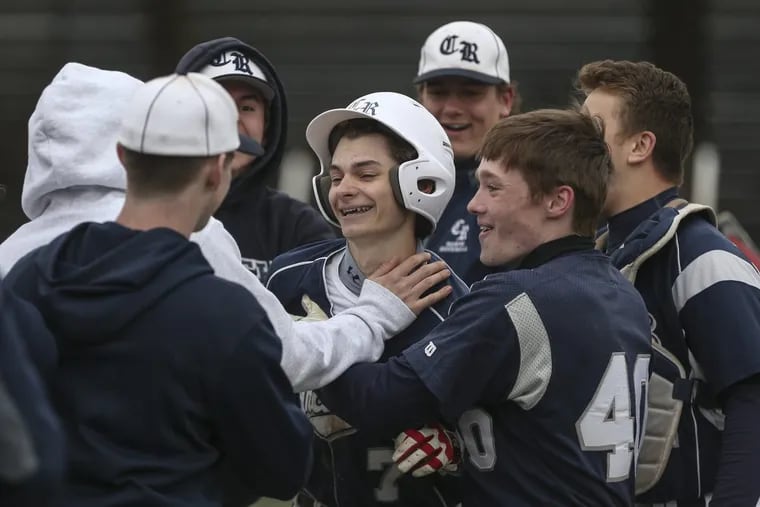 Council Rock North's CJ Donofry, center, celebrates his two run homer against Neshaminy with teammates during the 7th inning in Langhorne, Tuesday, April 17, 2018.