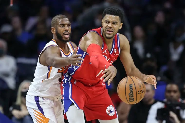 Sixers Tobias Harris throws a pass around Suns Chris Paul during the 1st quarter at the Wells Fargo Center in Philadelphia on Thursday.