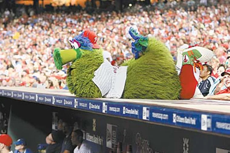 The Phillie Phanatic wears a 35-pound furry getup and dances, at times, in searing heat. But Tom Burgoyne endures. (RON CORTES / Staff Photographer)