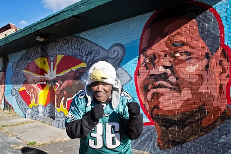 Paul "Earthquake" Moore next to a mural painted in his honor at James Finnegan Playground in West Philadelphia on November 28,
2014.