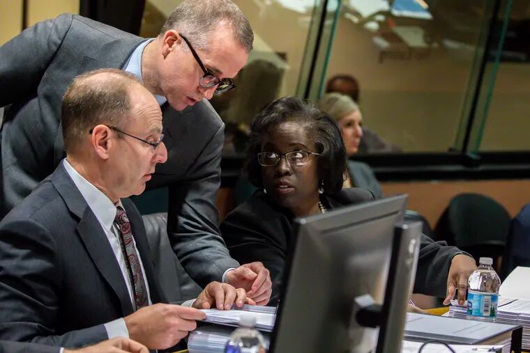 Prosecutors Ron Safer, from left, Brian Watson and Patricia Brown Holmes confer during the trial of Chicago Police Officer Thomas Gaffney, former Detective David March and ex-Officer Joseph Walsh at Leighton Criminal Court Building in Chicago on Tuesday, Dec. 4, 2018 in Chicago. Prosecutors in the trial of the three Chicago police officers charged with lying about the shooting of black teenager Laquan McDonald have rested their case. The move Tuesday came after a witness read emails that prosecutors contend suggest the officers' superiors were intent on protecting the white police officer who fired the fatal shots. (Zbigniew Bzdak/Chicago Tribune via AP, Pool)