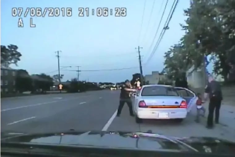 In this image made from July 6, 2016, video captured by a camera in the squad car of St. Anthony Police officer Jeronimo Yanez, the Minnesota police officer is shown after shooting into the vehicle at Philando Castile during a traffic stop in Falcon Heights, Minn., as the 4-year-old daughter of Castile's girlfriend, Diamond Reynolds, starts to get out of the car and is grabbed by an officer. The video was made public by the Minnesota Bureau of Criminal Apprehension and the Ramsey County Attorney's Office, Tuesday, June 20, 2017, just days after the officer was acquitted on all counts in the case.