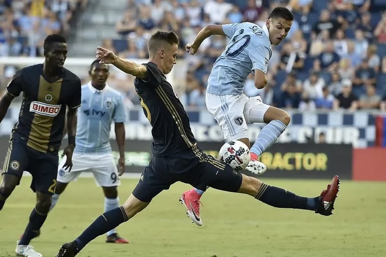 Sporting Kansas City’s Daniel Solloi (30) and the Philadelphia Union’s Jack Elliot battle for control of the ball in the first half of Thursday’s game.