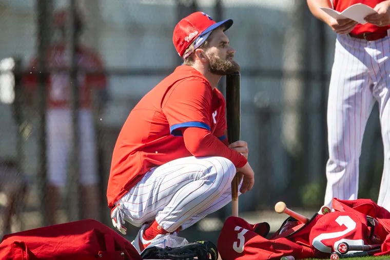 Bryce Harper takes a break during the Phillies' spring-training workout Thursday at the Carpenter Complex.