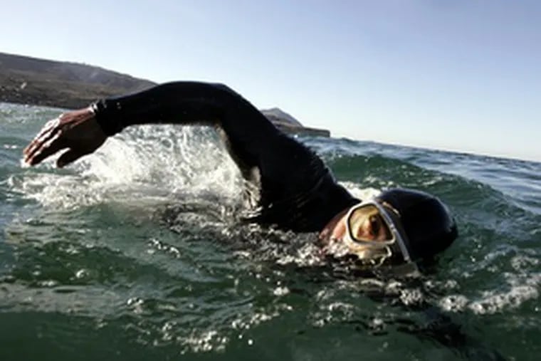 Valencia swims off Ensenada , top, using his muscular arms and shoulders to drag his legs through the water. Above, he displays his powerful upper body. His long-distance swimming feats once were celebrated. With a sponsor, he says, he could conquer new challenges.