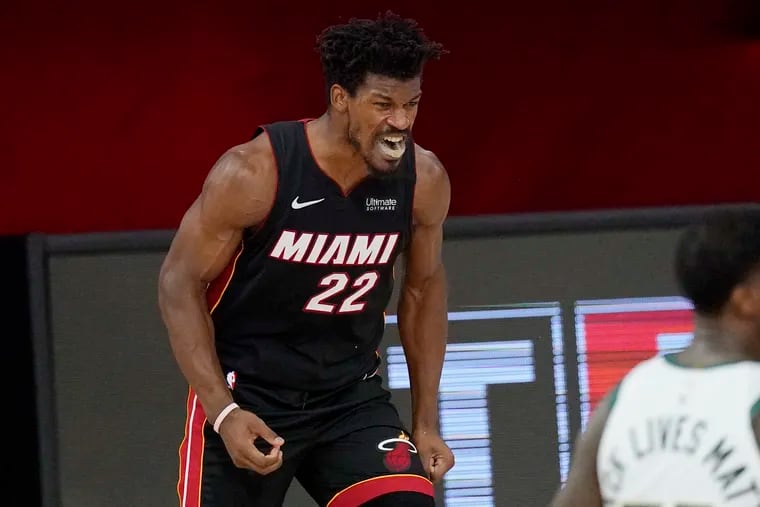 Miami Heat's Jimmy Butler (22) celebrates after a dunk in the second half of an NBA conference semifinal playoff basketball game against the Milwaukee Bucks on Friday in Lake Buena Vista, Fla.