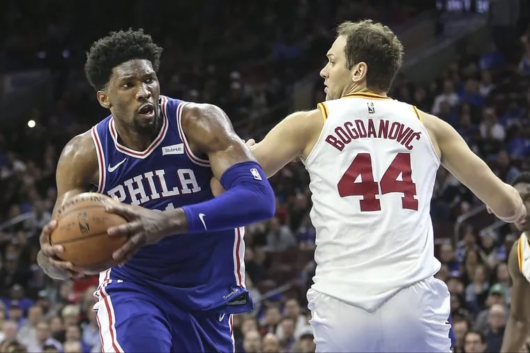 The Sixers want Joel Embiid (left) to attack the rim more.