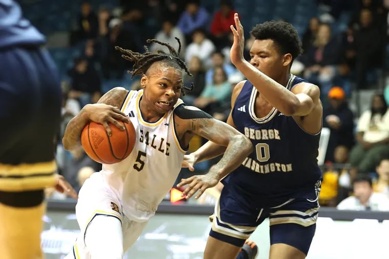 Khalil Brantley (left), seen against George Washington in the last game at Tom Gola Arena, scored 15 points as La Salle narrowly edged GW in the first round of the Atlantic 10 Tournament on Tuesday.