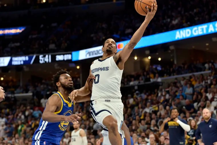 Grizzlies guard De'Anthony Melton goes up for a layup against of Warriors forward Andrew Wiggins in the first half during Game 1 of a second-round playoff series on May 1.
