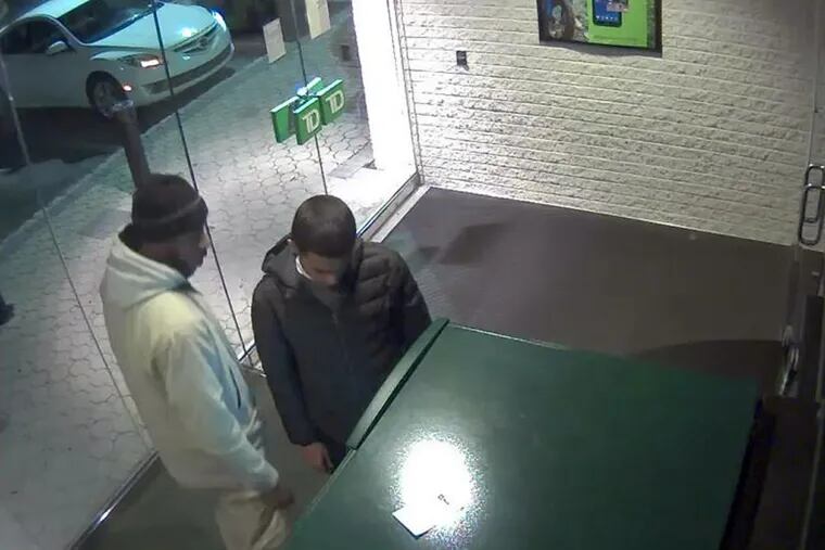 A surveillance photo from a TD Bank branch shows two men suspected in the Thanksgiving slaying of Ryan Kelly, 21, in Port Richmond.
