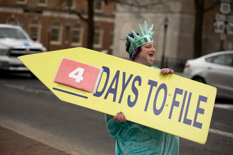 Stacey Blessing, of Carlisle, dances in a Statue of Liberty costume to advertise Liberty Tax Services at High and Hanover Streets in Carlisle, Pa. Blessing, who mostly listens to 90s pop while working said, “If you’re going to do a job like this you have to pay attention to the weather and you have to know your body and your limitations.” The federal tax deadline is April 15.