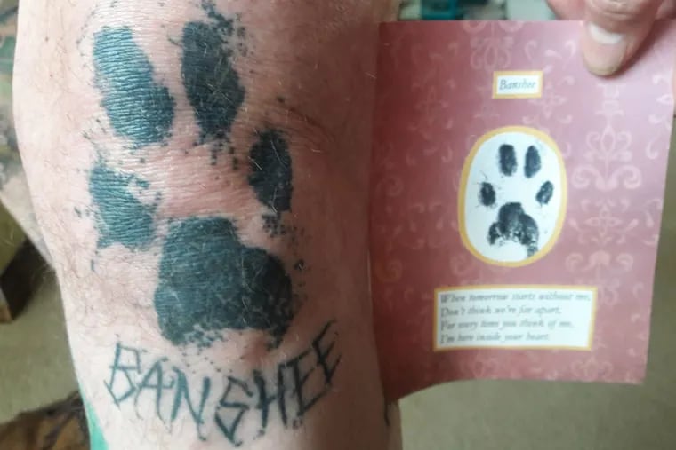 Timothy Shallbetter had his veterinarian take paw prints of his cat, Banshee, at the time of the cat’s cremation. Timothy sprinkled some of the cat’s ashes into one of the ink cups to incorporate his remains into the tattoo memorial.