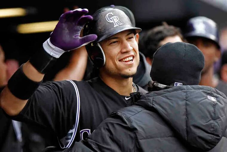 Colorado's Carlos Gonzalez celebrates with teammates after hitting his second home run of the day. Gonzalez connected off Arizona's Aaron Heilman in the Rockies' 12-4 rout.
