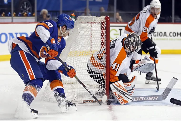 Flyers goaltender Anthony Stolarz makes a save on Kieffer Bellows in the second period of a preseason game Tuesday. The Flyers defeated the Islanders, 5-1.