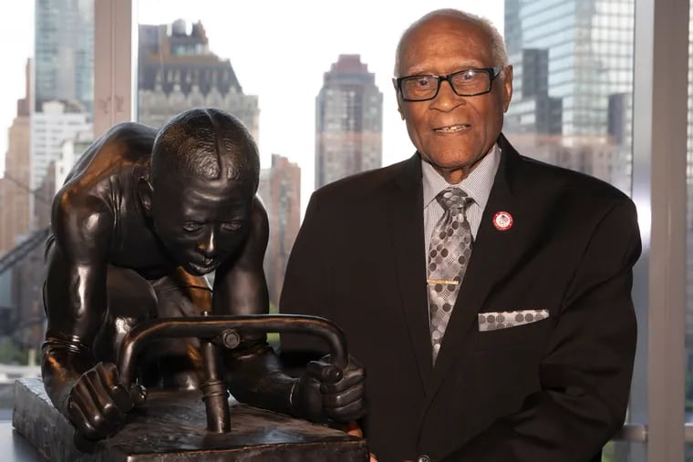 Mr. Douglas poses in 2019 in New York at the unveiling of a sculpture by Kadir Nelson called "The Major." It honors celebrated Black cyclist Marshall “Major” Taylor.
