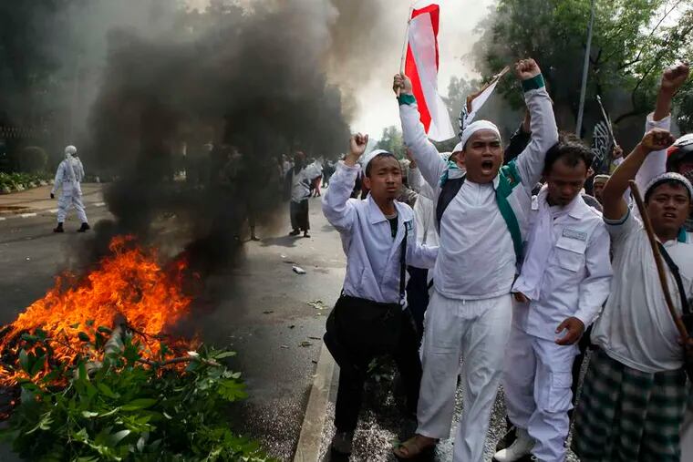 In Jakarta, Indonesia, protesters shout during a demonstration. Hundreds of Indonesians clashed with police Monday near the U.S. Embassy.