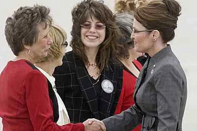 Republican volunteers from Montgomery County (from left) Eileen Petrille, Corinne Morgan, Traci Dallas-Opdahl, Mary Obel and Joanne Markey (hidden), meet Alaska Governor Sarah Palin on the tarmac Thursday in Philadelphia. (Jessica Griffin  / Inquirer)