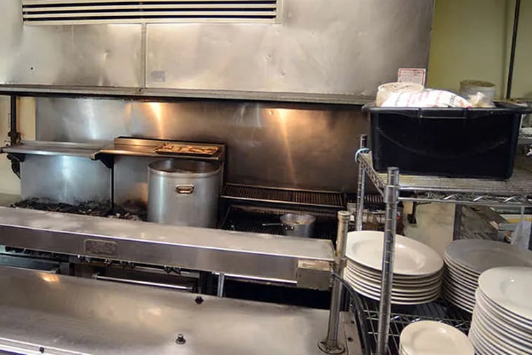 Main prep area and stovetop at Jack's Firehouse in Fairmount. Owner Mick Houston had nothing but praise for the sanitarians who found violations. TOM GRALISH / Staff Photographer
