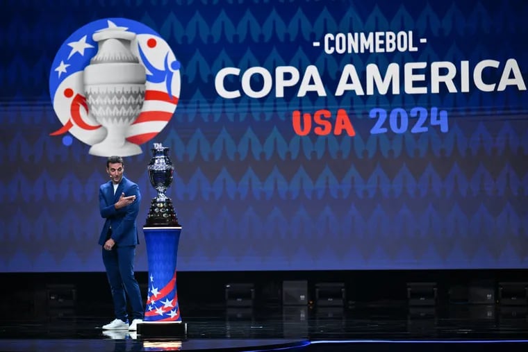 Reigning Copa América and World Cup champion Argetina's manager Lionel Scaloni on stage with the Copa América trophy at Thursday's draw in Miami.