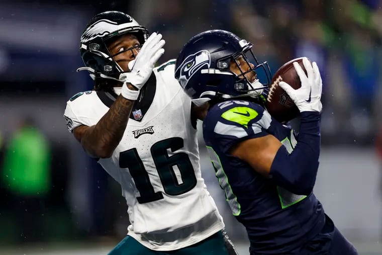 Seattle Seahawks safety Julian Love, right, intercepts the pass intended for Eagles wide receiver Quez Watkins, left, during the fourth quarter of the game at Lumen Field in Seattle, Wash. on Monday, Dec. 18, 2023.