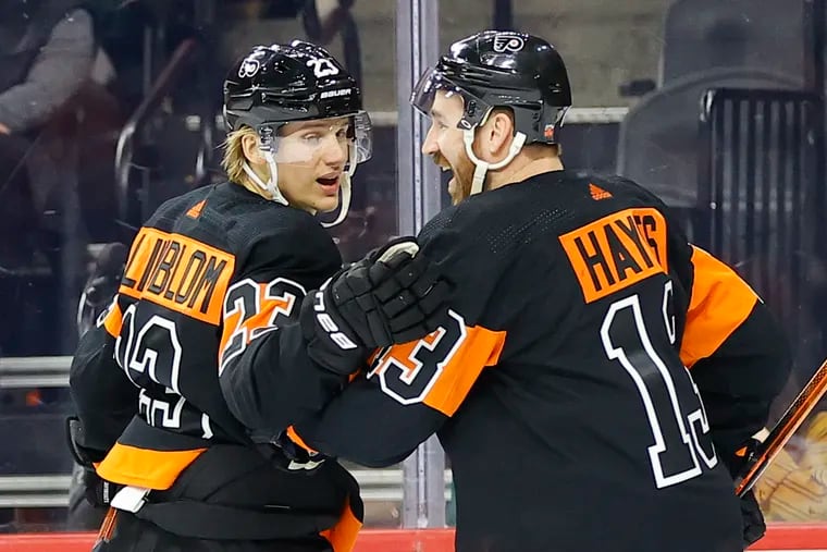 Flyers left wing Oskar Lindblom celebrates his first period goal with teammate center Kevin Hayes against the Chicago Blackhawks on Saturday, March 5, 2022 in Philadelphia.