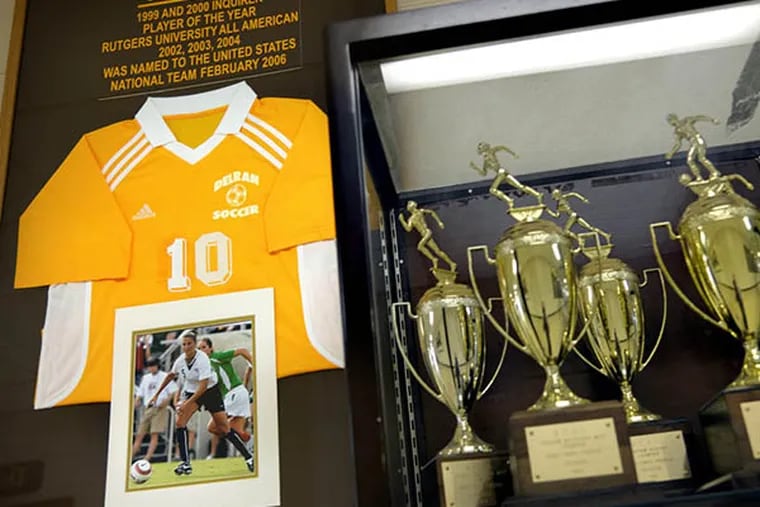 The jersey of hometown hero Carli Lloyd (DHS Class of 2001) at the Delran High School trophy case July 6, 2015, the day after she scored a hat trick in the World Cup final. ( TOM GRALISH / Staff Photographer )
